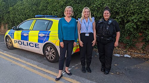 Lisa Smart with GMP and mental health nurse in front of police car